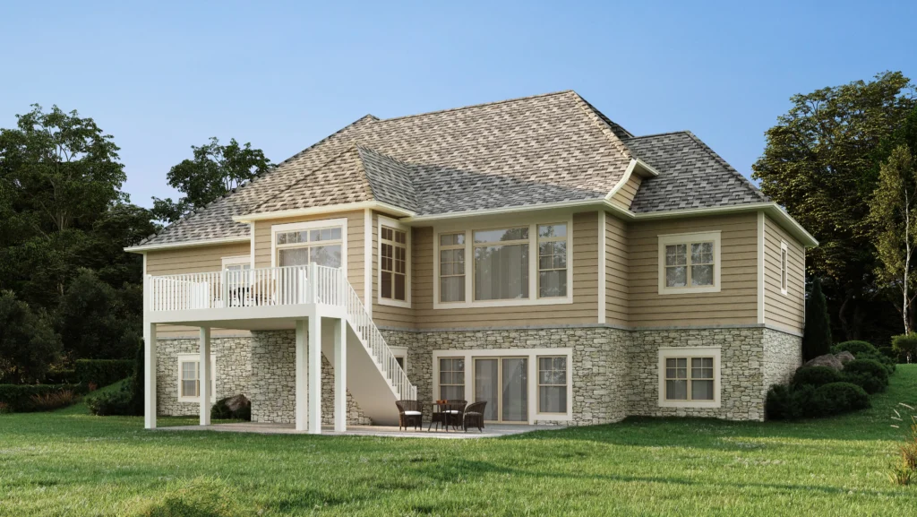 Two-story house with a gabled roof, large windows, stone and siding exterior, elevated deck, and lawn surrounded by trees under a clear blue sky.